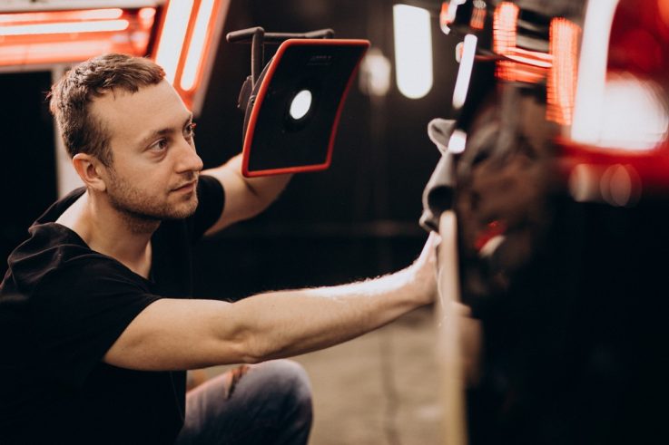 technik używa sprzętu do napraw bez lakierowania